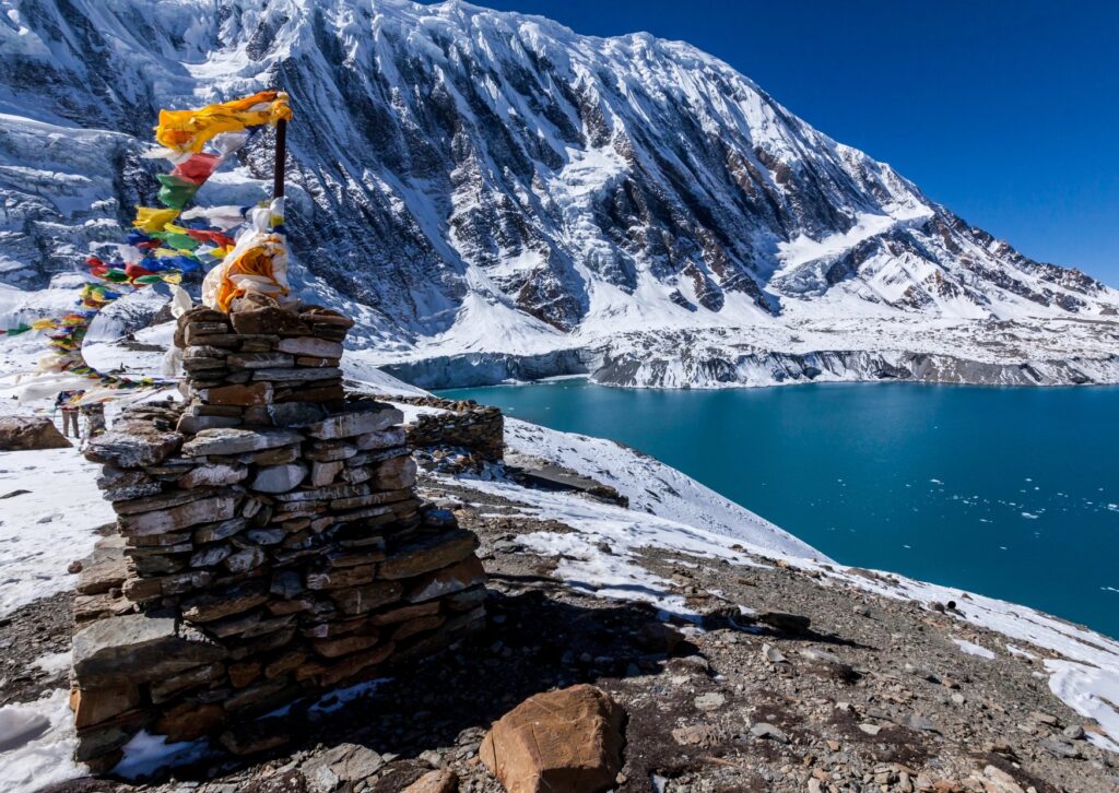 A serene mountain landscape featuring a lake in the foreground and a majestic mountain in the background.