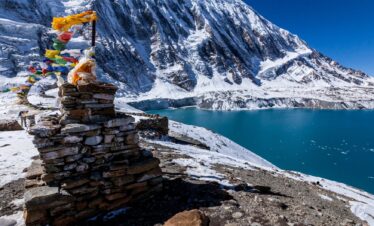 A serene mountain landscape featuring a lake in the foreground and a majestic mountain in the background.