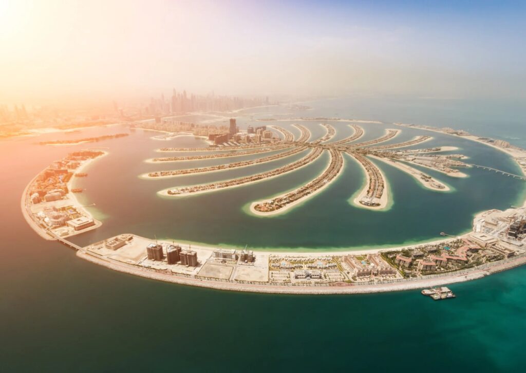 Aerial view of Palm Island in Dubai, showcasing its unique shape and luxury resorts, a popular tourist destination.