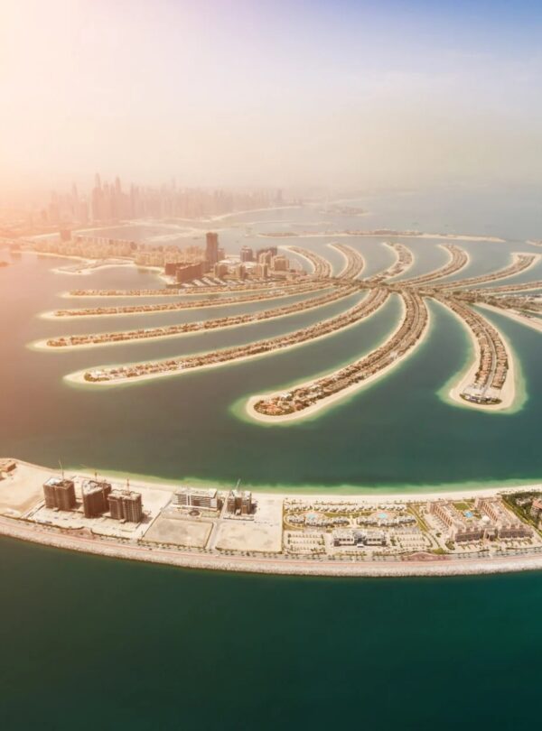 Aerial view of Palm Island in Dubai, showcasing its unique shape and luxury resorts, a popular tourist destination.
